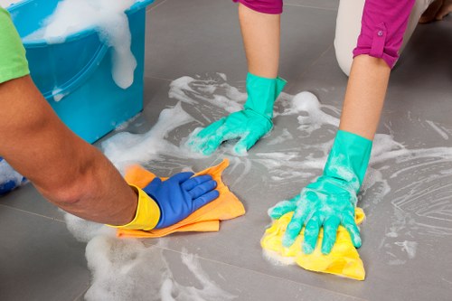 Domestic cleaner tidying a kitchen in a West London home