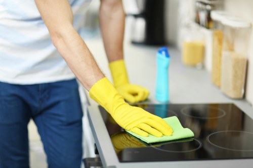Staff member carrying out a careful deep cleaning task in Ealing